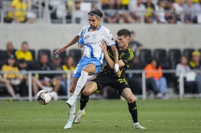 Aug 1, 2025; Columbus, Ohio, USA; Puebla forward Ricardo Marin (19) battles for the ball against Columbus Crew midfielder Sean Zawadzki (25) in the second half at Lower.com Field. Mandatory Credit: Aaron Doster-Imagn Images