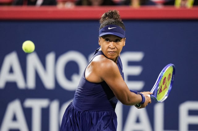 Aug 5, 2025; Montreal, QC, Canada; Naomi Osaka (JPN) returns the ball to Elina Svitolina (UKR) in quarterfinal play at IGA Stadium. Mandatory Credit: David Kirouac-Imagn Images