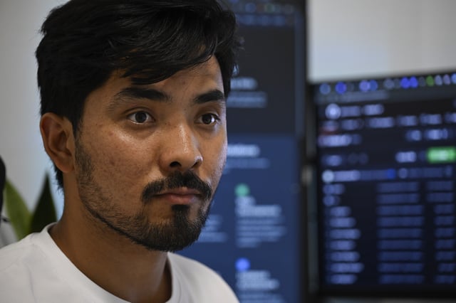 Murtaza Jafari, 25, an Afghan migrant, listens to a question during an interview with The Associated Press, after teaching coding remotely to women currently living in Afghanistan, in Athens, Greece, Wednesday, July 23, 2025. (AP Photo/Michael Varaklas)