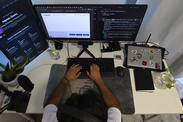 Murtaza Jafari, 25, an Afghan migrant, sits in front of his computer while teaching coding remotely to women currently living in Afghanistan, in Athens, Greece, Wednesday, July 23, 2025. (AP Photo/Michael Varaklas)