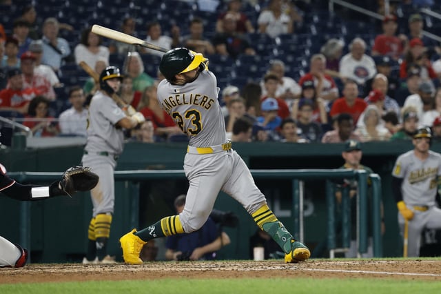 Aug 5, 2025; Washington, District of Columbia, USA; Athletics catcher Shea Langeliers (23) hits a home run against the Washington Nationals during the seventh inning at Nationals Park. Mandatory Credit: Geoff Burke-Imagn Images