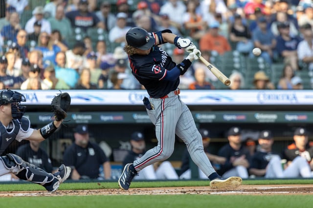 Aug 5, 2025; Detroit, Michigan, USA; Minnesota Twins outfielder Luke Keaschall (15) hits a two run home run in the first inning against the Detroit Tigers at Comerica Park. Mandatory Credit: David Reginek-Imagn Images
