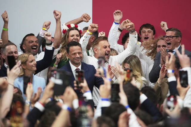 FILE - Presidential candidate Rafal Trzaskowski, a liberal pro-European Union figure, center, arrives at his headquarters after the presidential election runoff in Warsaw, Poland, Sunday, June 1, 2025. (AP Photo/Petr David Josek, File)