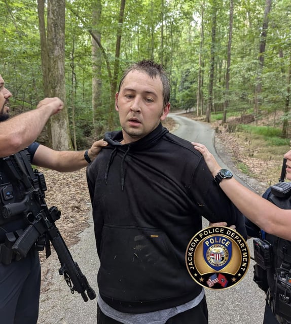 A photo shared by the Jackson Police Department shows Austin Drummond as he as being taken into custody on Tuesday, August 5. Drummond was captured in a wooded area shortly after 8am local time, according to authorities.