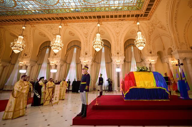 Priests perform a brief religious service next to the coffin of the late Ion Iliescu, Romania's first freely elected president after the fall of communism in 1989, at the Cotroceni Presidential Palace, in Bucharest, Romania, Wednesday, Aug. 6, 2025.(AP Photo/Vadim Ghirda)
