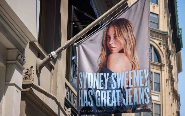 An advertisement featuring actress Sydney Sweeney outside an American Eagle store in New York, US, on Aug. 4,. American Eagle Outfitters Inc. shares surged after US President Donald Trump came out in support of a controversial ad from the company featuring actress Sydney Sweeney.