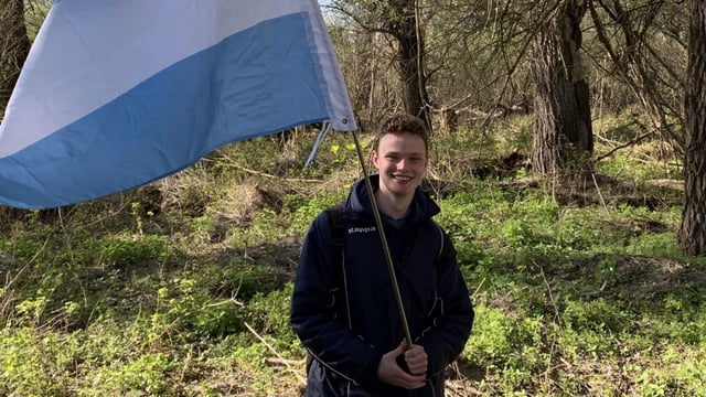 Daniel Jackson holding a flag