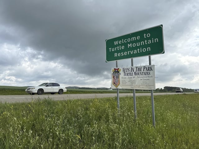 Vehicles pass by the boundary sign for the Turtle Mountain Reservation in northern North Dakota on Wednesday, July 23, 2025. (AP Photo/Jack Dura)
