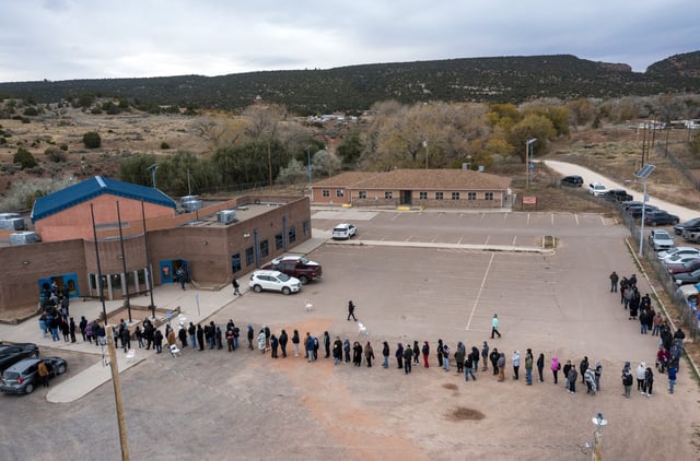 FILE - Voters wait in line to cast their ballots outside a polling station on the Navajo Nation in Fort Defiance, Ariz., on Election Day, Nov. 5, 2024. (AP Photo/Andres Leighton, File)