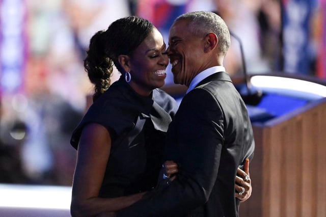 Former U.S. President Barack Obama hugs his wife and former First Lady, Michelle Obama, after she introduced him on the second day of the Democratic National Convention (DNC) at the United Center in Chicago, Illinois, on August 20, 2024.