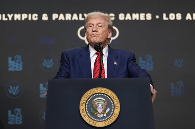President Donald Trump listens to a question from a reporter after signing an executive order about the 2028 Los Angeles Olympic Games, in the South Court Auditorium of the Eisenhower Executive Office Building on the White House campus, Tuesday, Aug. 5, 2025, in Washington.