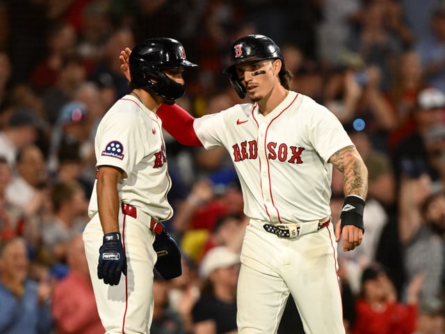 BOSTON, MASSACHUSETTS - AUGUST 05: Jarren Duran #16 of the Boston Red Sox celebrates with. David Hamilton #17 after scoring a run against the Kansas City Royals during the seventh inning at Fenway Park on August 05, 2025 in Boston, Massachusetts.