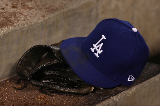 LOS ANGELES, CALIFORNIA - APRIL 26: A detailed view of a Los Angeles Dodgers hat and catching glove is seen on the dugout steps during the sixth inning of the MLB game between the Pittsburgh Pirates and the Los Angeles Dodgers at Dodger Stadium on April 26, 2019 in Los Angeles, California. The Dodgers defeated the Pirates 6-2. (Photo by Victor Decolongon/Getty Images)