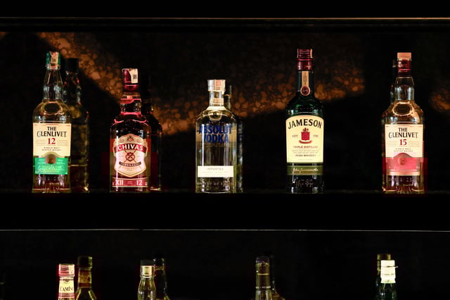 Bottles of Pernod Ricard's brands are displayed at a bar in Gurugram, India, November 26, 2024. REUTERS/Priyanshu Singh/File Photo