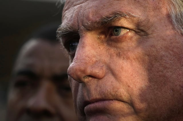 FILE - Former President Jair Bolsonaro speaks to the press after testifying to the federal police on an investigation involving his son, former Congressman Eduardo Bolsonaro, in Brasilia, Brazil, June 5, 2025. (AP Photo/Eraldo Peres, File)