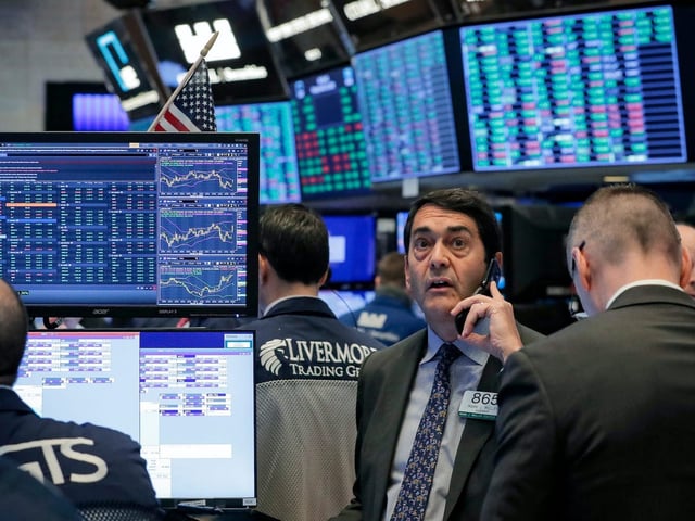 Traders work on the floor of the New York Stock Exchange (NYSE) in New York, U.S., March 20, 2020