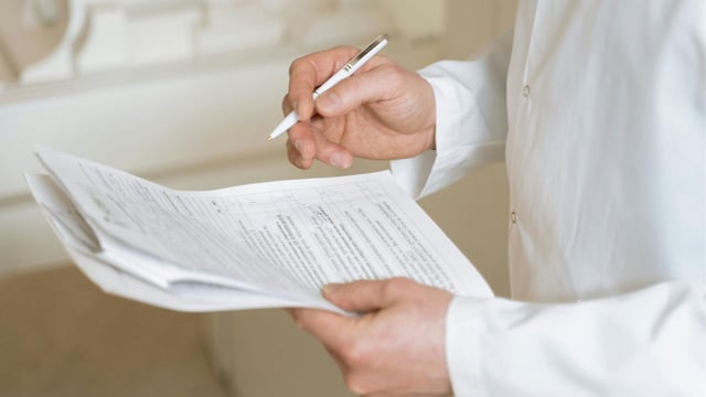 Doctor holding a pen and paper