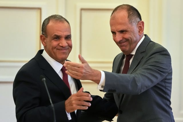Egyptian Foreign Minister Badr Abdelatty, left, and his Greek counterpart George Gerapetritis shake hands after a news conference in Athens, Greece, Wednesday, Aug. 6, 2025. (AP Photo/Thanassis Stavrakis)