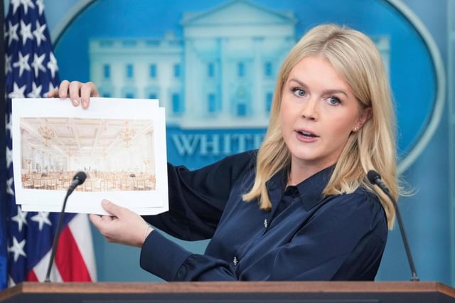 White House press secretary Karoline Leavitt holds up photos of the planned new White House ballroom during a press briefing at the White House in Washington, Thursday, July 31, 2025. (AP Photo/Mark Schiefelbein)