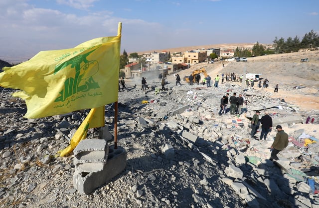 A Hezbollah flag flutters at a site damaged in the aftermath of an Israeli strike on the town of Al-Ain in the Baalbek region, in Lebanon, November 6, 2024. REUTERS/Mohammed Yassin/File Photo