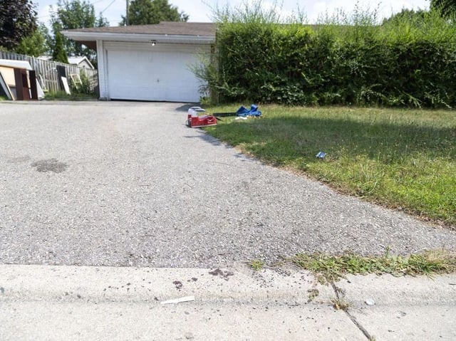Blood stains are visible on the bottom of a driveway at 2 Breton Park Cres. in London following a melee involving as many as six males that left a 27-year-old man with fatal injuries on Sunday, Aug. 3, 2025. Photo taken on Tuesday Aug. 5, 2025. (Derek Ruttan/The London Free Press)