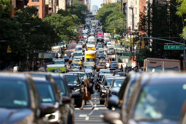 Cars and pedestrians move along  2nd Avenue in the Manhattan borough of New York City on July 29, 2025. 
