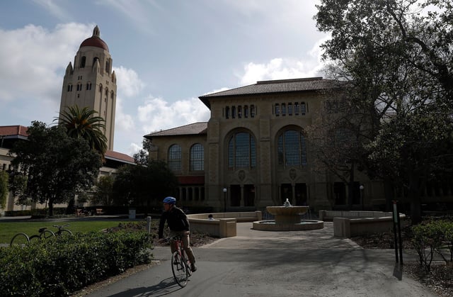 A cyclist rides their bicycle on the Stanford University campus on March 28 in Stanford, California.