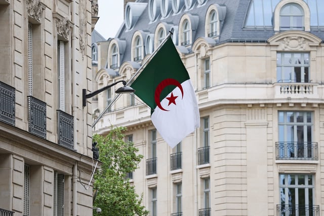 The Algerian flag flies on the facade of the Algerian Embassy in Paris, France, April 16, 2025. REUTERS/Gonzalo Fuentes/File Photo