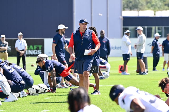 Jul 23, 2025; Foxborough, MA, USA; New England Patriots head coach Mike Vrabel walks though plays warming up before day one of training camp at Gillette Stadium. Mandatory Credit: Eric Canha-Imagn Images/File Photo