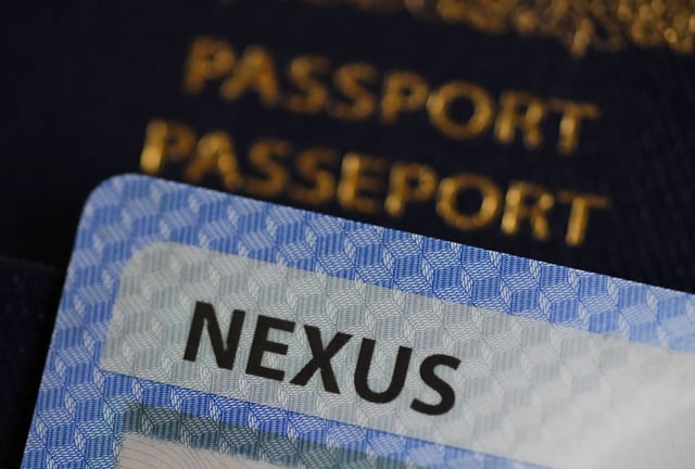 A Nexus ID card on top of a Canadian passport