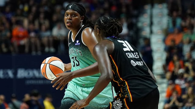Aug 1, 2025; Uncasville, Connecticut, USA; New York Liberty center Jonquel Jones (35) looks to pass the ball against Connecticut Sun center Tina Charles (31) in the second half at Mohegan Sun Arena. Mandatory Credit: David Butler II-Imagn Images