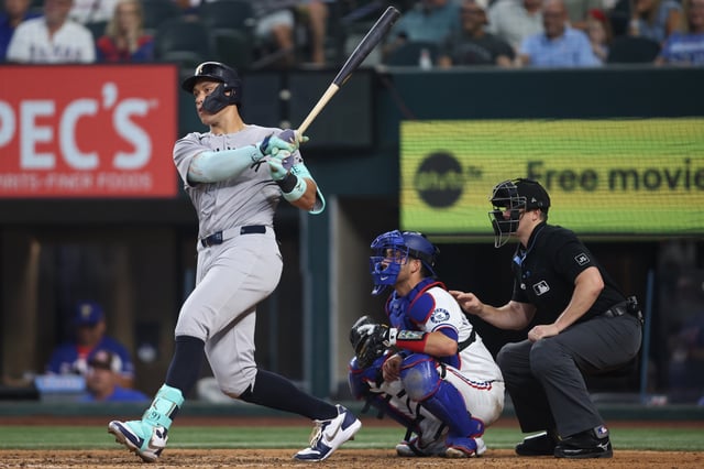 Aug 6, 2025; Arlington, Texas, USA; New York Yankees designated hitter Aaron Judge (99) hits a single during the seventh inning against the Texas Rangers at Globe Life Field. Mandatory Credit: Tim Heitman-Imagn Images