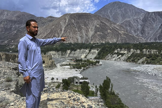 Businessman Saqib Hassan gestures toward debris of his family homes, which were damaged by July 22 floods, at the bank of Hunza River in Sarwarabad, a town in the northern Pakistan, Wednesday, Aug. 6, 2025. (AP Photo/Abdul Rehman)