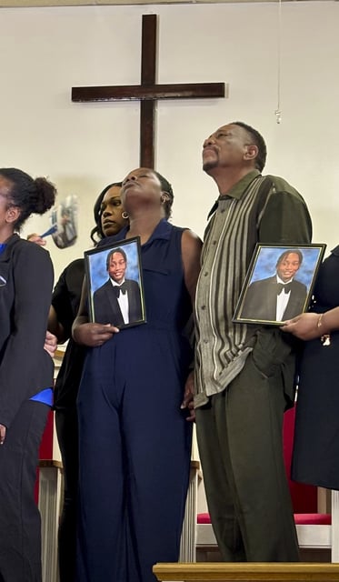 Vivian Sterling, left, and William Peoples hold a photo of their son, Jabari Peoples, during a press conference in Homewood, Ala., Tuesday, July 8, 2025. (AP Photo/Kim Chandler)