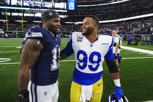 Micah Parsons #11 of the Dallas Cowboys talks with Aaron Donald #99 of the Los Angeles Rams after an NFL game at AT&amp;T Stadium on October 29, 2023 in Arlington, Texas.