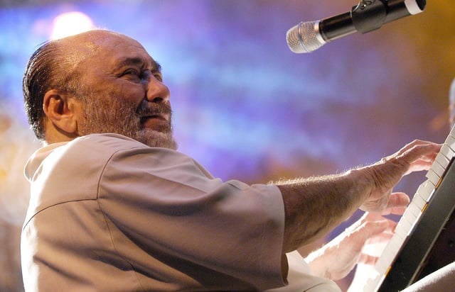 FILE - Grammy Award winner Eddie Palmieri performs during his concert "Listen Here" at Tito Puente Amphitheatre in San Juan, Puerto Rico, April 7, 2005. (AP Photo/Herminio Rodriguez, File)