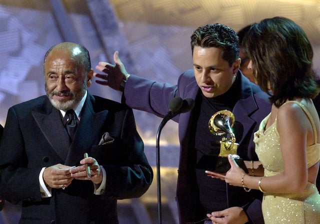 FILE - Tito Puente Jr., center, speaks after Eddie Palmieri, left, and the late Tito Puente win the Grammy for best salsa album for "Masterpiece/Obra Maestra," at the 43rd annual Grammy Awards, Feb. 21, 2001, at the Staples Center in Los Angeles. (AP Photo/Kevork Djansezian, File)