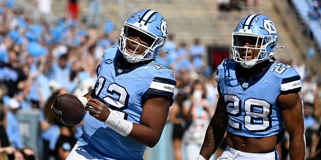 North Carolina Tar Heels quarterback Jacolby Criswell (12) celebrates with running back Omarion Hampton (28) after scoring a touchdown in the first quarter at Kenan Memorial Stadium. Mandatory Credit: Bob Donnan-Imagn Images