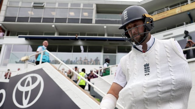 England's Chris Woakes walks out to bat with a dislocated shoulder