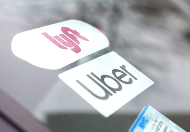 Lyft and Uber brand logos are in the dashboard of cars when the New York Taxi Workers Alliance (NYTWA) Uber and Lyft hold a work stoppage at a lot near LaGuardia airport on Sunday, February 26, 2023 in New York City. The strike kicked off with a rally and speak-out at the LaGuardia Uber/Lyft cell phone lot followed by picket lines throughout the airport. Photo by John Angelillo/UPI Photo via Newscom picture alliance