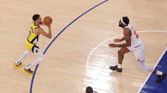 May 21, 2025; New York, New York, USA; Indiana Pacers guard Tyrese Haliburton (0) shoots a game-tying two point shot to send the game to overtime in the fourth quarter against New York Knicks center Mitchell Robinson (23) during game one of the eastern conference finals for the 2025 NBA Playoffs at Madison Square Garden. Mandatory Credit: Brad Penner-Imagn Images.