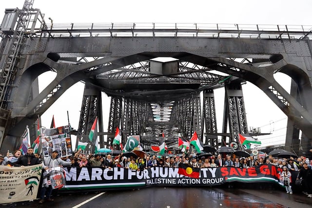 SYDNEY, AUSTRALIA - 2025/08/03: Protesters march across the Sydney Harbour Bridge during the rally. Thousands of protesters took part in the &#34;March for Humanity Save Gaza,&#34; crossing the Sydney Harbour Bridge to call for an end to Israel&#39;s military assault on Gaza and demand immediate humanitarian aid access. The march was part of a broader movement across Australia condemning the bombardment, displacement, and civilian deaths in the besieged territory. Protesters also raised urgent concerns over the deepening food crisis, with the United Nations warning that more than a million Palestinians in Gaza are facing catastrophic hunger, particularly children suffering from severe malnutrition. (Photo by Ye Myo Khant/SOPA Images/LightRocket via Getty Images)