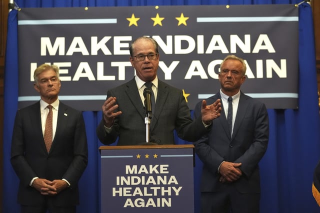 FILE - Indiana Governor Mike Braun is joined by U.S. Health and Human Services Secretary Robert F. Kennedy, Jr, right, and Centers for Medicare and Medicaid Services Administrator Dr. Mehmet Oz during a news conference in Indianapolis, April 15, 2025. (AP Photo/Michael Conroy, File)
