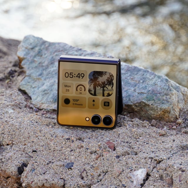 The Samsung Galaxy Z Flip 7 sitting near a stream.