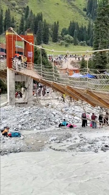 Aftermath of a suspension bridge collapse in Yili, Xinjiang Uyghur Autonomous Region, China in this screen grab obtained from a social media video on date given as August 6, 2025. Social Media/via REUTERS