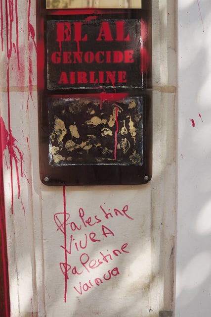 A view of slogans 'EL AL genocide airline' and 'Palestine will live and will win', sprayed with red paint on the entrance of the EL AL Israel Airlines offices in Paris, France August 7, 2025. REUTERS/Noemie Olive
