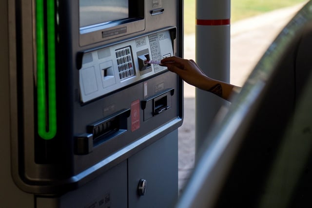 A customer uses a drive-thru automated teller machine (ATM) at a Bank of America Corp. branch.