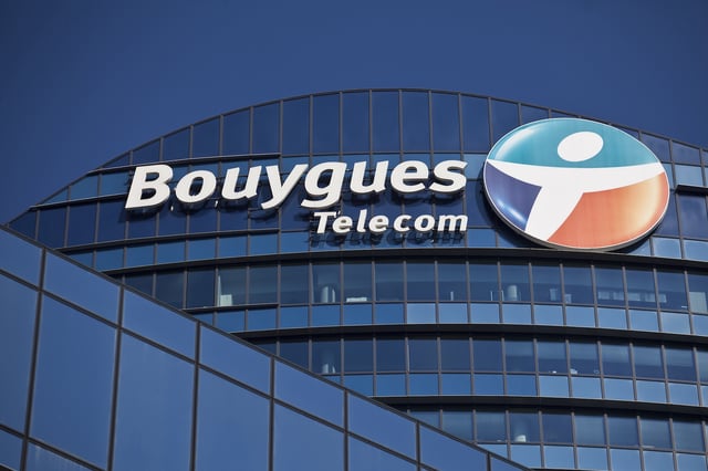 A logo sits outside the headquarters of Bouygues Telecom, a unit of Bouygues SA, the construction and telecommunications group led by Martin Bouygues, in Paris, France, on Thursday, March 6, 2014. Vivendi, Europe's largest media-to-telecommunications group, said it received two bids for the French phone unit SFR it was planning to spin off. Photographer: Balint Porneczi/Bloomberg