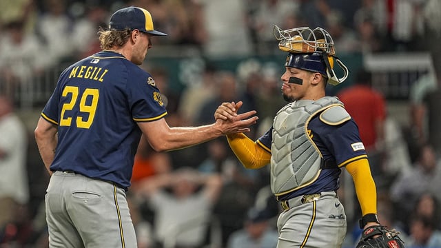 Aug 6, 2025; Cumberland, Georgia, USA; Milwaukee Brewers pitcher Trevor Megill (29) and catcher William Contreras (24) react after defeating the Atlanta Braves at Truist Park. Mandatory Credit: Dale Zanine-Imagn Images