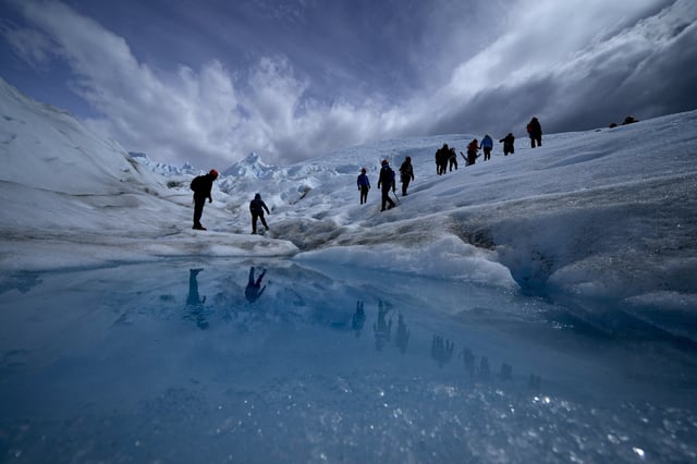 FILE - Tourists walk on the Perito Moreno Glacier at Los Glaciares National Park, near El Calafate, Argentina, Nov. 2, 2021. (AP Photo/Natacha Pisarenko, File)